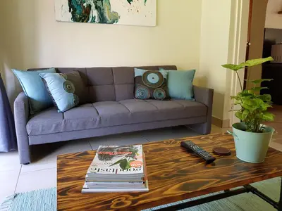 a living room with a couch and a coffee table at Kington Guest Suite in Pretoria