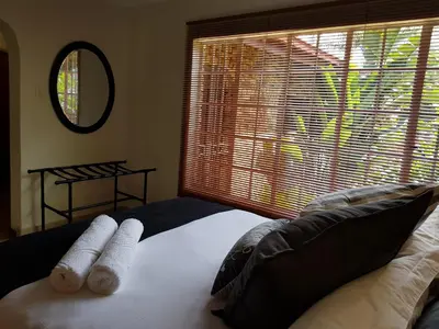 a bedroom with a bed with two towels on it at Kington Guest Suite in Pretoria