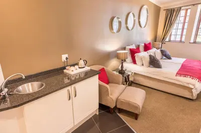 a bedroom with a bed and a sink in a room at Constantia Hotel and Conference Centre in Midrand