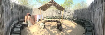 a zoo exhibit with a table and chairs at Masingitana Tented Camp in Hoedspruit
