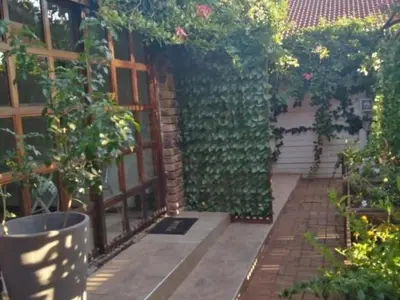 a garden with a wall of plants and a door at 8 Soenie Avenue Self-Catering in Pretoria