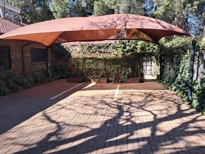 a brick walkway with an umbrella on top of it at 8 Soenie Avenue Self-Catering in Pretoria