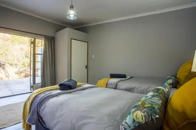 a room with two beds and a window at Rivendell Trout Estate in Lydenburg