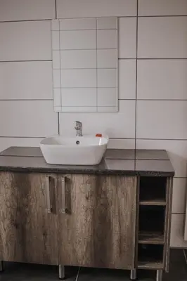 a bathroom with a sink and a mirror at Casa Leitao Lodge in Phalaborwa