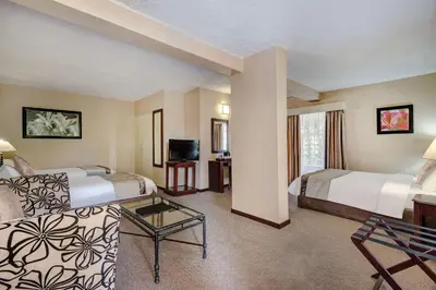 a hotel room with two beds and a television at Hazyview Sun in Hazyview