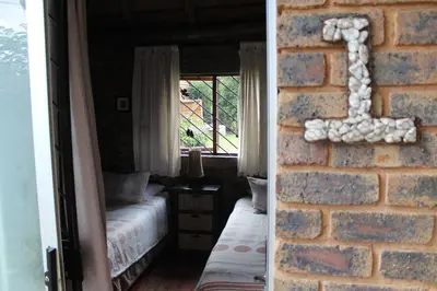 a room with a brick wall and a window at 1322 Backpackers International in Pretoria