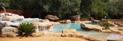 a pool of water with a waterfall and rocks at Boulders Safari Lodge in Malelane