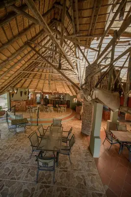 a room with tables and chairs and a large ceiling at Boulders Safari Lodge in Malelane