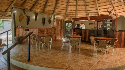 a dining room with tables and chairs in a house at Boulders Safari Lodge in Malelane