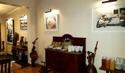a room with a wooden cabinet with jars on it at African Roots Guest House in Polokwane