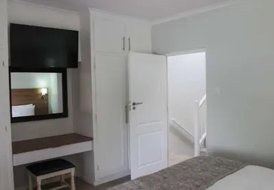 a bedroom with a bed and a closet with a mirror at Pine Lake Resort in White River