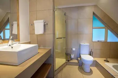 a bathroom with a sink and a toilet and a shower at Pine Lake Resort in White River