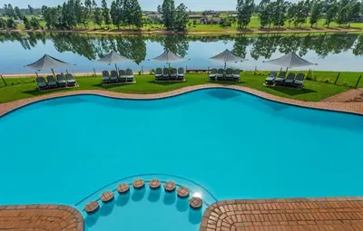 an aerial view of a resort pool with chairs and umbrellas at Pine Lake Resort in White River