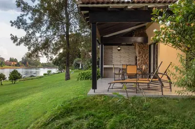 a patio with chairs and a table in front of a house at Pine Lake Resort in White River