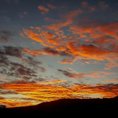 a sunset with clouds in the sky at Graceland Eco Retreat in Magoebaskloof