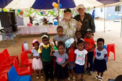 a group of children and an older man posing for a picture at Pungwe Safari Camp in Manyeleti Game Reserve