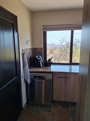 a kitchen with a dishwasher and a window with a view at Dream Of Nature in Bela-Bela