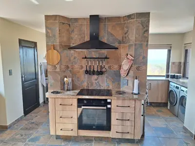 a kitchen with a sink and a stove at Dream Of Nature in Bela-Bela