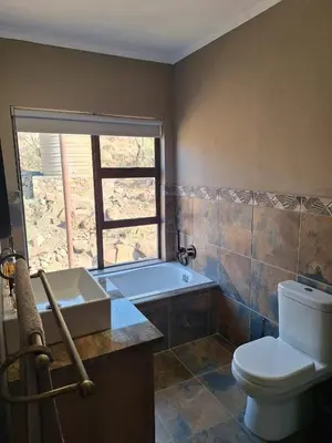 a bathroom with a tub and a toilet and a sink at Dream Of Nature in Bela-Bela