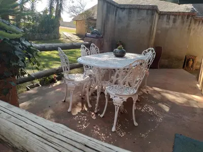 a white table and chairs on a patio at Anna Boeremeisie Guesthouse in Benoni
