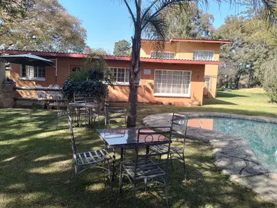 a table and chairs in front of a house at Anna Boeremeisie Guesthouse in Benoni