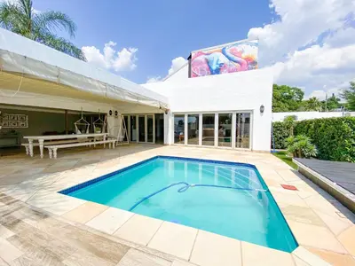 a swimming pool in the backyard of a house at TCS on Lynnwood Guesthouse in Pretoria