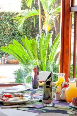 a table with breakfast food and orange juice on it at TCS on Lynnwood Guesthouse in Pretoria