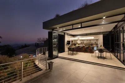 an outdoor kitchen and dining area of a house at Angels View Hotel in Graskop