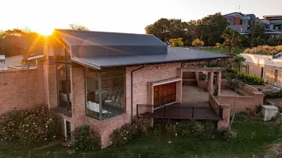 a house with a solar roof on top of it at Angels View Hotel in Graskop