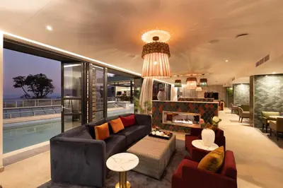 a living room with a couch and a fireplace at Angels View Hotel in Graskop