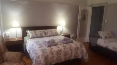 a bedroom with a bed with two pillows on it at Pretoria Inn in Pretoria