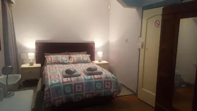 a bedroom with a bed with towels on it at Pretoria Inn in Pretoria