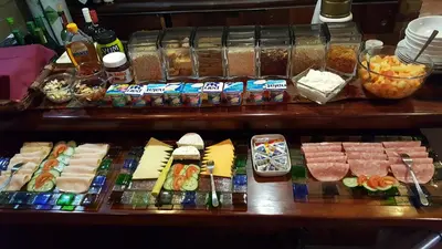 a buffet with cheese and meats and other foods at Crocodile Lodge cc in Midrand