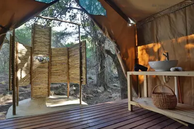 a room in a tent with a window at Southern Sands Eco Lodge in Hoedspruit