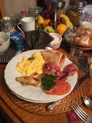 a plate of breakfast food with eggs bacon and toast at Sunninghill Sojourn in Kyalami