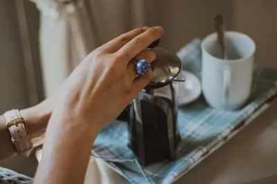 a woman with her hand on top of a tea kettle at Three Olives Guesthouse in Centurion