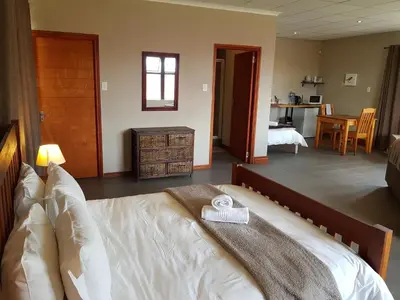 a bedroom with a bed with a towel on it at Stay@67 Apartments - Dullstroom in Dullstroom