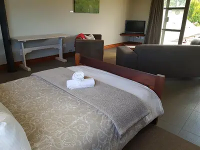 a bedroom with a bed with a towel on it at Stay@67 Apartments - Dullstroom in Dullstroom
