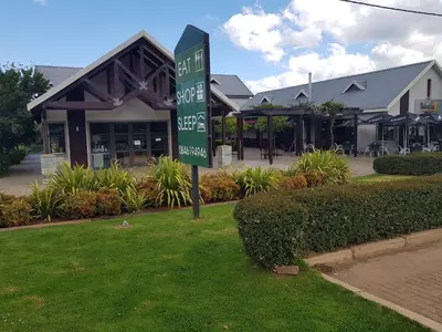 a green street sign in front of a store at Stay@67 Apartments - Dullstroom in Dullstroom