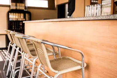 a row of chairs sitting next to a counter in a store at Ruby Stone Boutique Hotel in Polokwane