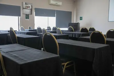 an empty room with tables and chairs in a classroom at Ruby Stone Boutique Hotel in Polokwane