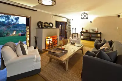 a living room with couches and a fireplace at The Blades in Pretoria