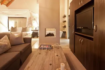 a living room with a couch and a tv at The Blades in Pretoria