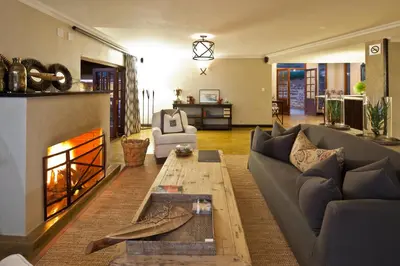 a living room with a couch and a fireplace at The Blades in Pretoria