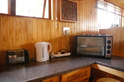 a kitchen counter with a microwave and a toaster oven at Yorkdale Cabin in Sabie