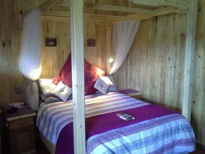 a bedroom with a bed with a canopy at Yorkdale Cabin in Sabie