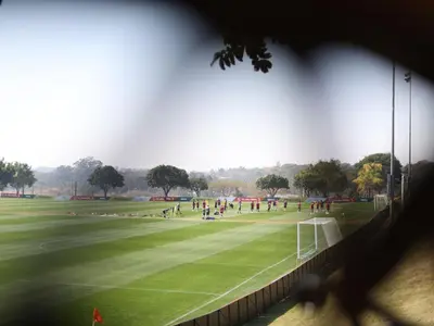 a group of people playing soccer on a field at ANEW Resort White River Mbombela in White River