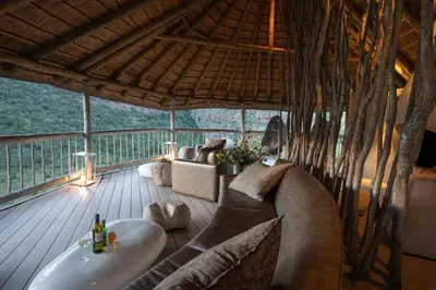 a bathroom with a tub and a sink on a deck at Clifftop Exclusive Safari Hideaway in Welgevonden Game Reserve