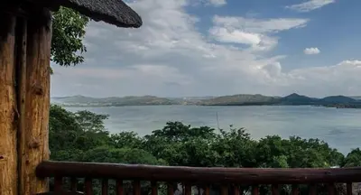 a view of a large body of water from a porch at Hartbeespoortdam Lodge in Hartbeespoort