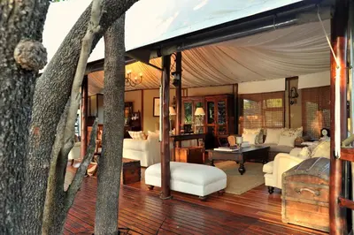 a living room with a couch and a table at Hamiltons Tented Camp in Mluwati Concession